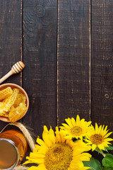 Wall Mural - Honey in a glass jar, honeycombs. Products of beekeeping on a wooden table, top view. The concept of healthy eating. Honey theme.