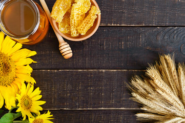 Wall Mural - Honey in a glass jar, honeycombs. Products of beekeeping on a wooden table, top view. The concept of healthy eating. Honey theme.