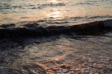 Wall Mural - Sea water texture in sunrise light.