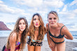 © simona - Portrait of three young female friends kissing the camera on the sea shore looking at camera laughing. Caucasian young women strolling along a beach. friendship together for women in vacation