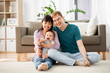 © Syda Productions - family, parenthood and people concept - happy mother and father with baby boy at home