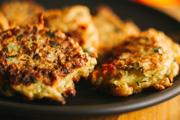 Fried vegetable fritters with zucchini, carrots, herbs, eggs, and cheese.