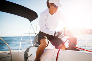 Wall Mural - Attractive strong woman sailing with her boat