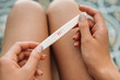 © LIGHTFIELD STUDIOS - cropped shot of young woman holding pregnancy test