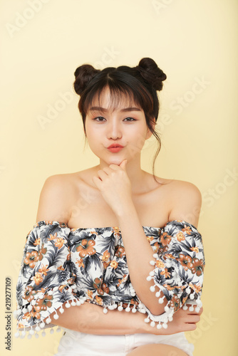 Portrait Of Beautiful Young Asian Woman With Hair Buns Pouting