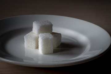 pieces of sugar lie on a white plate