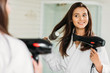 © LIGHTFIELD STUDIOS - happy young woman drying hair at mirror in bathroom