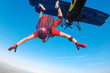 Skydiver in red jumping out of the plane