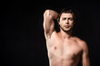 © LIGHTFIELD STUDIOS - portrait of handsome shirtless man looking at camera isolated on black