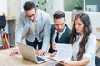 © Bojan - Business people in formal wear working with papers and laptop in modern office