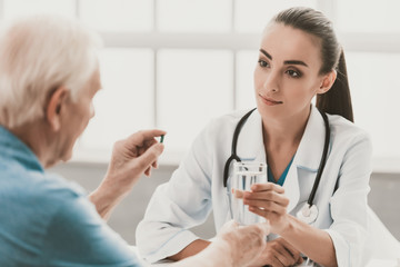 Canvas Print - Young Female Doctor and Patient Healthcare Concept