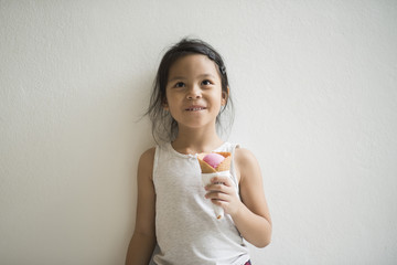 Wall Mural - Portrait of little girl eating ice cream with good feeling