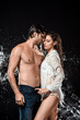 © LIGHTFIELD STUDIOS - side view of seductive couple swilled with water isolated on black
