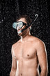 © LIGHTFIELD STUDIOS - portrait of shirtless man in swimming mask with snorkel standing under water drops isolated on black