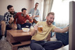 © ivanko80 - Cheerful group of friends watching football game on tv