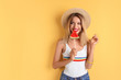 © New Africa - Pretty young woman with juicy watermelon on color background