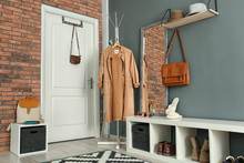 Stylish Hallway Interior With Mirror And Hanger Stand
