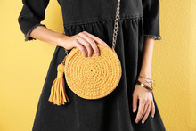 Young Woman In Stylish Outfit With Purse On Color Background, Closeup
