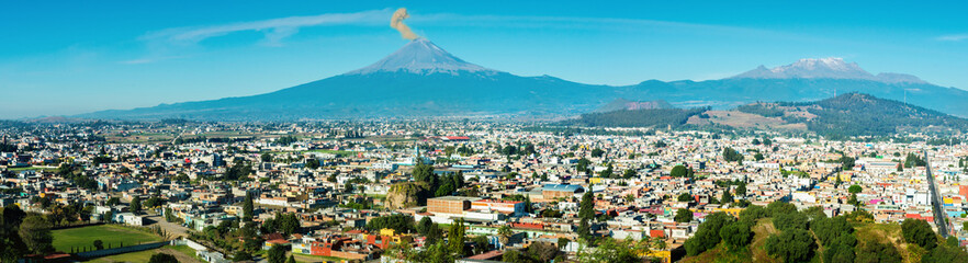 Eruption of Popocatepetl Volcano over the town of Puebla, Mexico, panoramic view