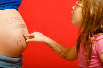 pregnant woman with her surprised daughter