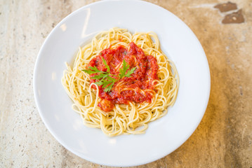 Delicious spaghetti pasta with tomato sauce and parsley, homemade healthy italian pasta on marble background, taste spaghetti