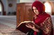 © FS-Stock - Young muslim woman praying in mosque with quran