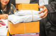 © saravuth - Woman receiving parcel from delivery man