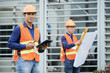 © DragonImages - Handsome young Vietnamese engineer with walkie-talkie controlling work on construction site