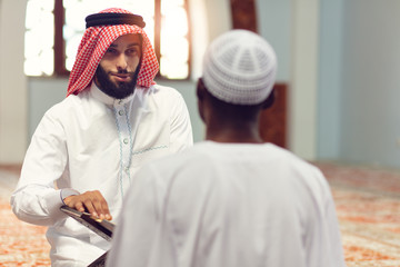 Poster - Two religious muslim man praying together inside the mosque