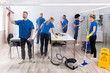 © Andrey Popov - Group Of Skilled Janitors Cleaning Office