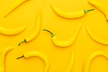Hot Chilli Peppers On The Yellow Background