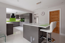 Contemporary Fitted Kitchen In Striking Lime Green, Grey And White Colour Scheme With Built In Appliances, White Granite Counter Tops Dual Ovens Island Breakfast Bar And Hob