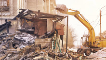 Demolition House Using Excavator In City. Rebuilding Process. Remove Equipment