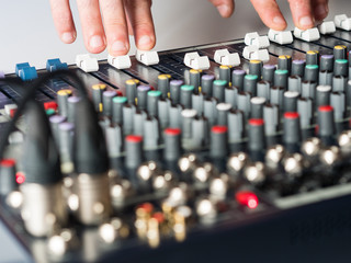 Man working on audio mixer in studio