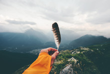Traveler Hand Holding Bird Feather Moody Mountains Landscape Aerial View Travel Adventure Lifestyle Concept Freedom And Solitude Emotions Harmony With Nature