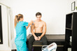 © AntonioDiaz - Physiotherapist Preparing Patient For Electrotherapy On Shoulder In Clinic