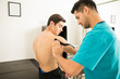© AntonioDiaz - Therapist Applying Elastic Therapeutic Tape On Shoulder Of Shirtless Man
