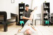 © AntonioDiaz - Physiotherapist Helping Mature Man With Leg Exercise In Clinic