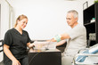 © AntonioDiaz - Physiotherapist Giving Electrotherapy To Patient At Table In Hospital