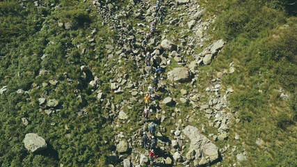 Wall Mural - drone view hiking group walking on mountain valley. aerial view mountains