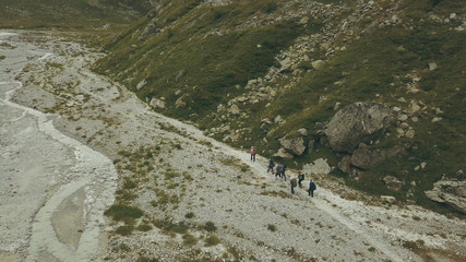 Wall Mural - view from above hiking group walking on mountain trail. climbing a mountain