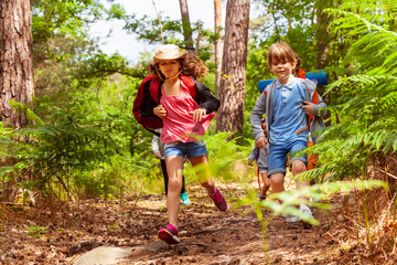 Boy and girl running in the forest