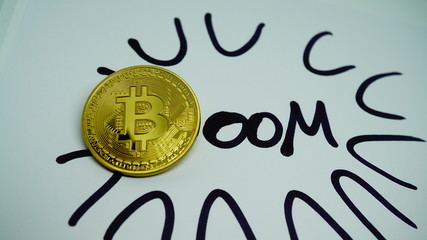 Written Boom with golden Bitcoin coin as a B. Conceptual photo for profit