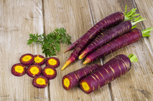 Sliced Purple Carrot On Wooden Background
