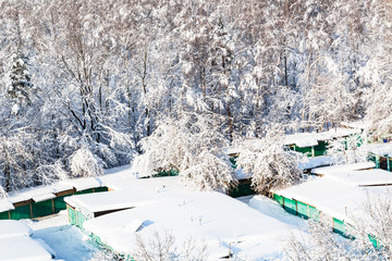 Wall Mural - above view of snow-covered garages and snowy park