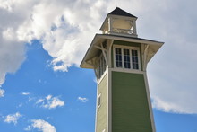 Orlando, Florida; August 19, 2018  Beautiful Victorian Lighthouse On Cloudy Blue Skyline, In Lake Buena Vista