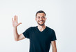 © GVS - Portrait of smiling man with hand raised in greeting