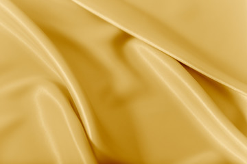 smooth elegant shiny gold silk or satin luxury cloth texture can use as abstract holidays background