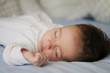 © javiindy - Newborn baby girl sleeping on blue sheets
