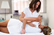© javiindy - Professional female physiotherapist giving shoulder massage to blonde woman
